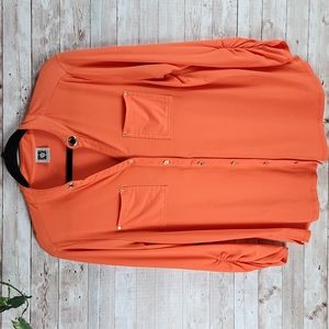 Anne klein, Women's orange top. Gold hardware on the opening of the collar.